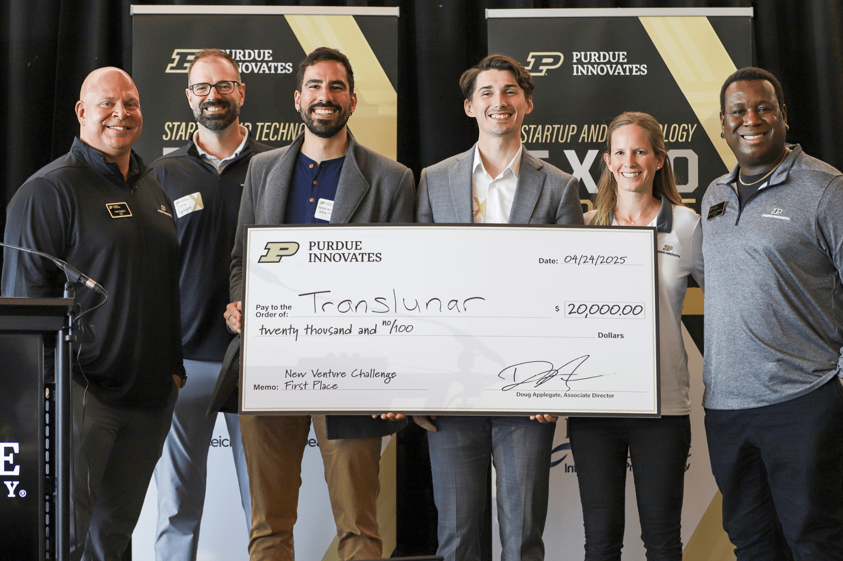Stellerian team receiving the \$20 000 first‑place check at the New Venture Challenge